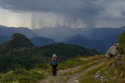 Rear view of man walking on mountain