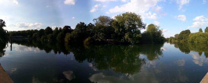 Panoramic view of lake and trees against sky