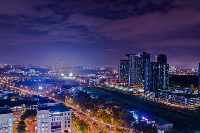 High angle view of illuminated buildings against sky at night