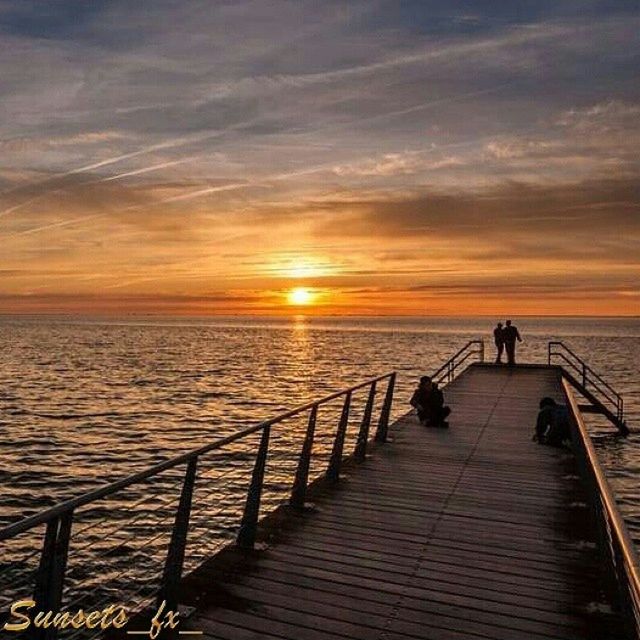 sunset, water, sea, horizon over water, scenics, sky, tranquil scene, tranquility, beauty in nature, sun, pier, railing, silhouette, orange color, nature, idyllic, the way forward, cloud - sky, jetty, beach