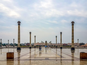 People walking on water against cloudy sky