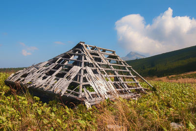 Built structure on field against sky