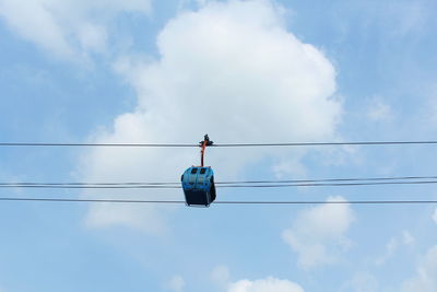 Low angle view of telephone pole against blue sky