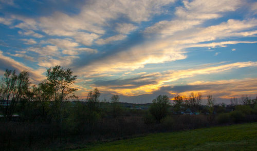 Scenic view of field against sky during sunset