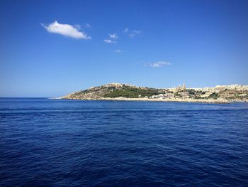 Scenic view of sea against blue sky