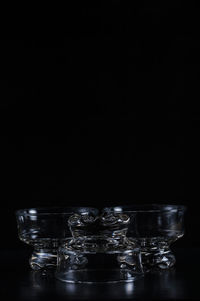 Close-up of glass bowls against black background