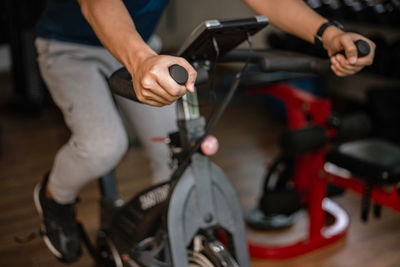 Midsection of man sitting on bicycle