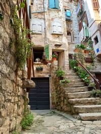 Low angle view of narrow alley amidst old building