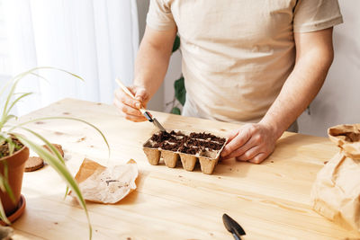 Midsection of woman preparing food on table