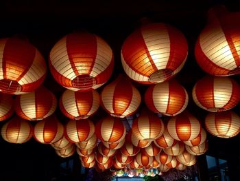 Low angle view of illuminated lanterns hanging on ceiling