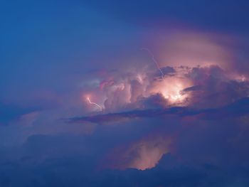 Low angle view of lightning in sky during sunset
