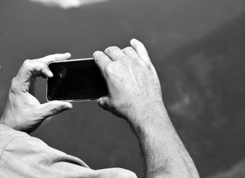 Midsection of man using mobile phone