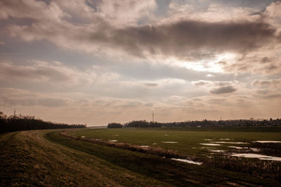 Scenic view of field against sky during sunset