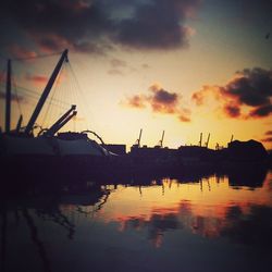 Boats in harbor at sunset