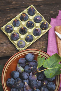 Purple black figs on a rustic wooden table