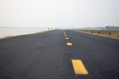 Surface level of road against clear sky