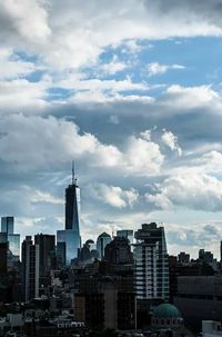 Cityscape against cloudy sky