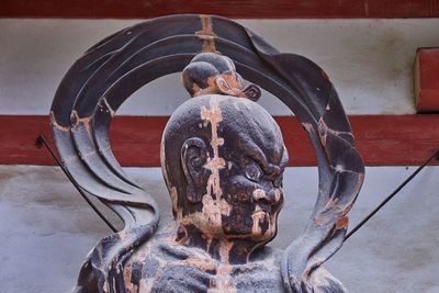 Close-up of statue against water