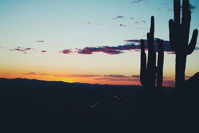 Silhouette landscape against sky during sunset