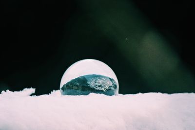 Close-up of frozen crystal ball  in winter