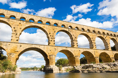 Low angle view of arch bridge over river