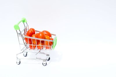 Close-up of orange tomatoes over white background