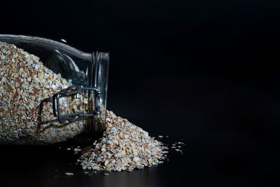 Close-up of glass on table against black background