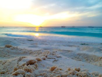 Scenic view of beach against sky during sunset