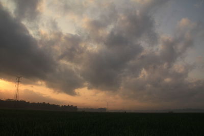 Scenic view of field against sky during sunset