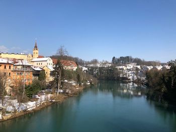 River in town against clear sky