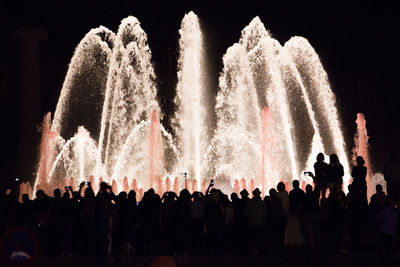 Group of people looking at fountain