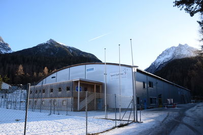 Built structure on snow covered landscape against clear sky
