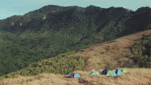 Panoramic view of tent on field against mountains