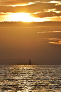 Scenic view of sea against orange sky