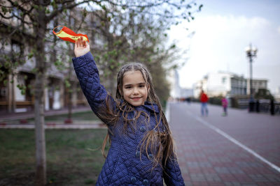 Portrait of smiling girl standing outdoors