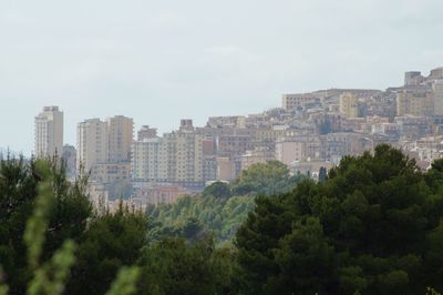 Buildings in city against sky