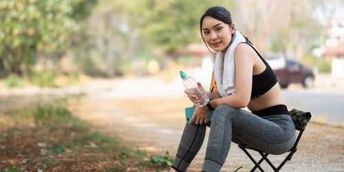 Young woman sitting outdoors