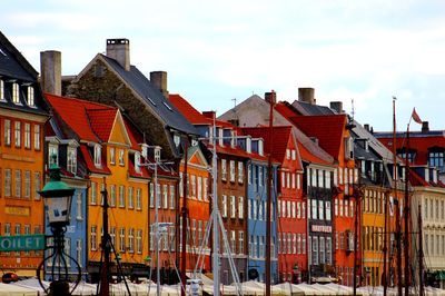 Houses in city against sky