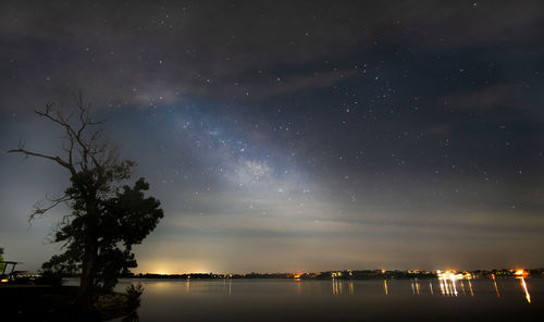 Scenic view of lake against sky at night