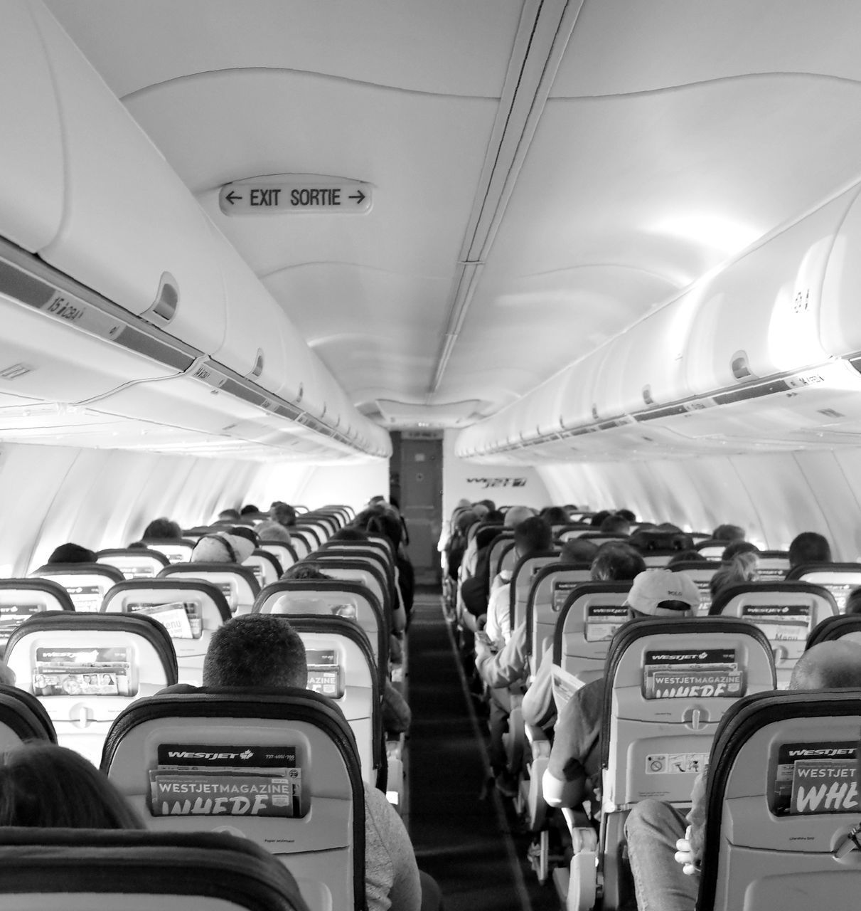 PEOPLE SITTING IN AIRPLANE AT AIRPORT