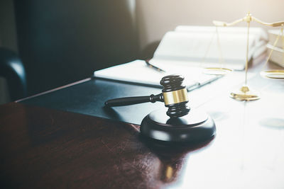 Close-up of gavel on table in office