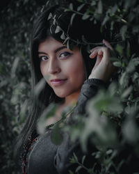 Portrait of young woman with leaves outdoors