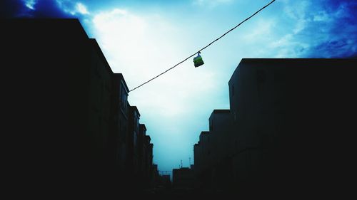 Low angle view of buildings against cloudy sky