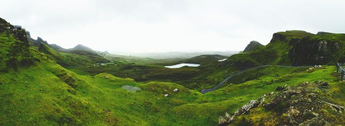 Scenic view of green landscape against sky