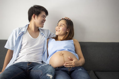 Young couple sitting outdoors