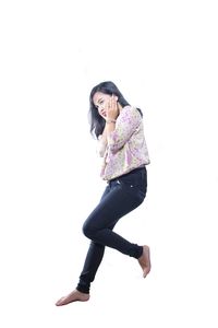 Portrait of young woman against white background