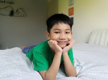 Portrait of boy on bed at home