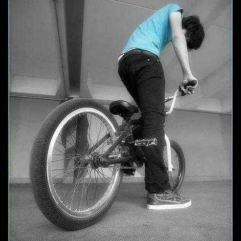 YOUNG WOMAN RIDING BICYCLE