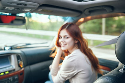 Portrait of smiling woman in car