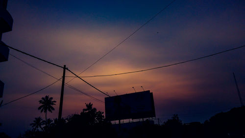 Low angle view of silhouette trees against sky at sunset